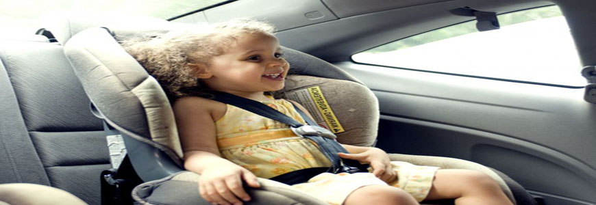 young cute female child in back seat car seat