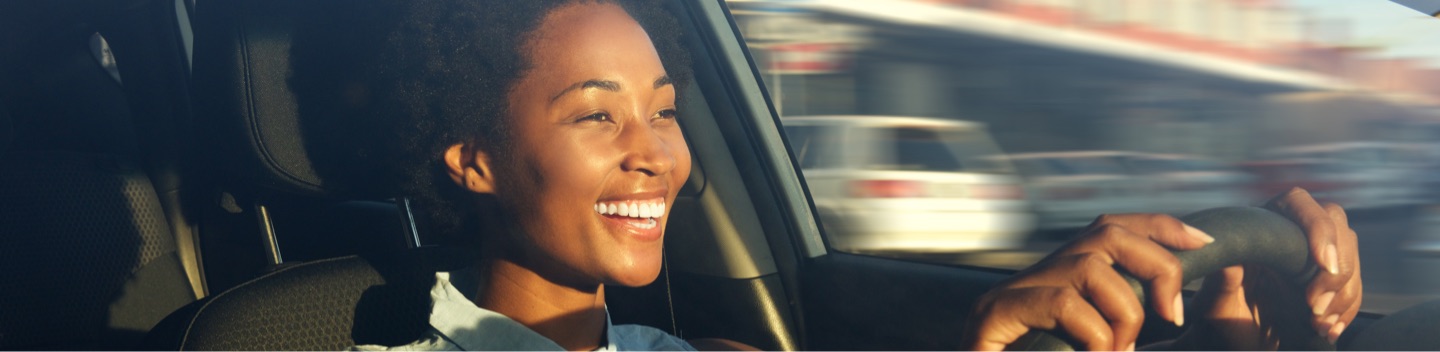 Smiling Woman Driving Car