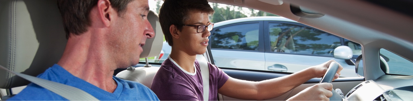 Student Driver And Instructor In Car