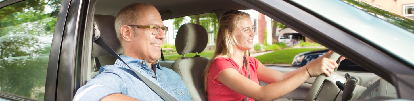 Student Driver And Instructor In Car