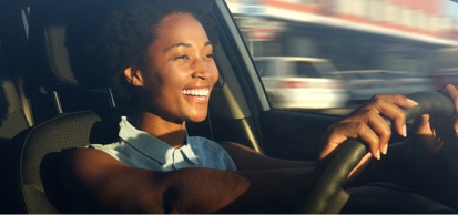 Smiling Woman Driving Car