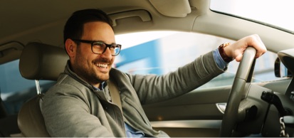 Smiling Man Driving Car Wearing Glasses