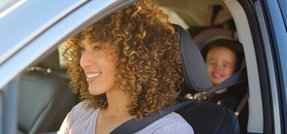 Woman Wearing Seatbelt With Baby In Car Seat